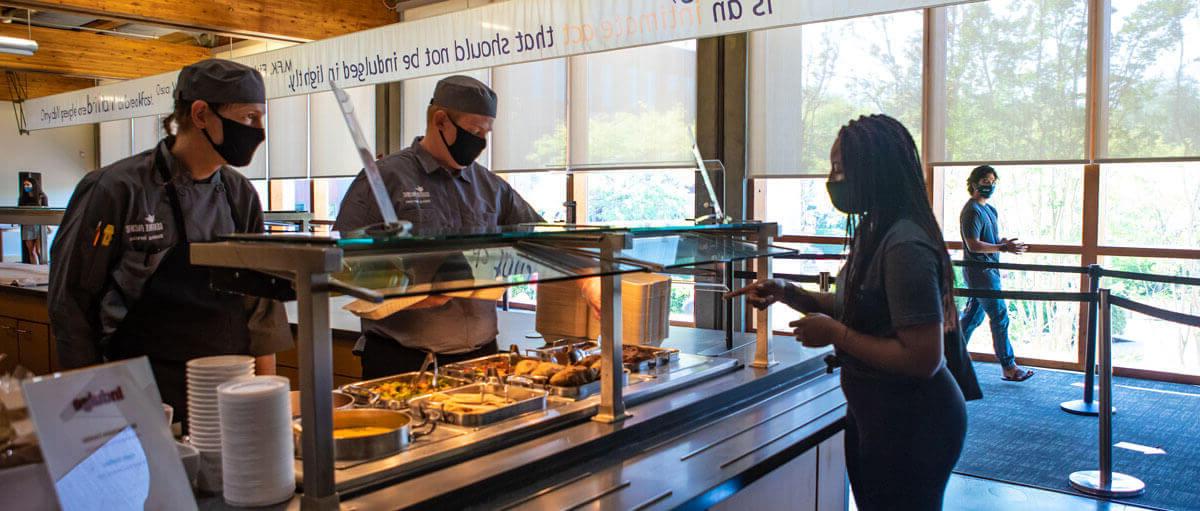 students holding food from Gwinn